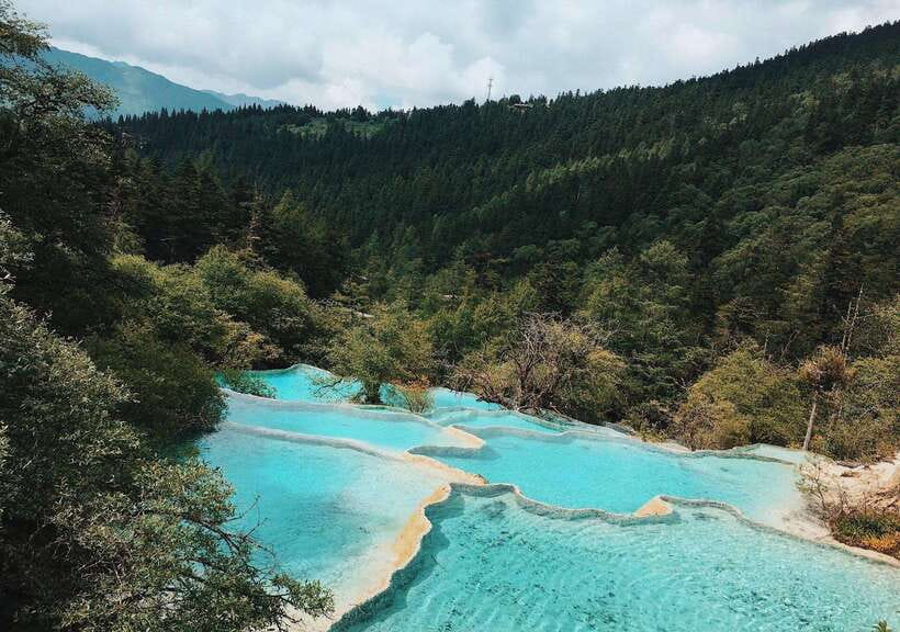 Huanglong Scenic Area: Explore Stunning Five-Colored Ponds - Huanglong compared with Jiuzhaigou